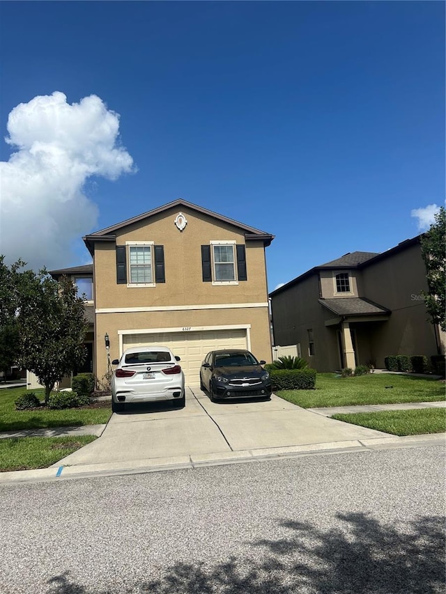 view of front of house with a front yard and a garage