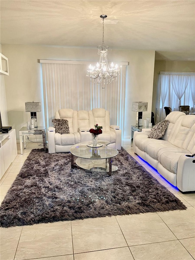 living room featuring light tile patterned floors and an inviting chandelier