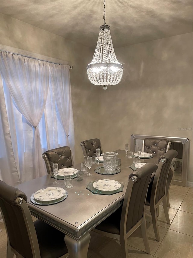 dining space featuring a notable chandelier and light tile patterned floors