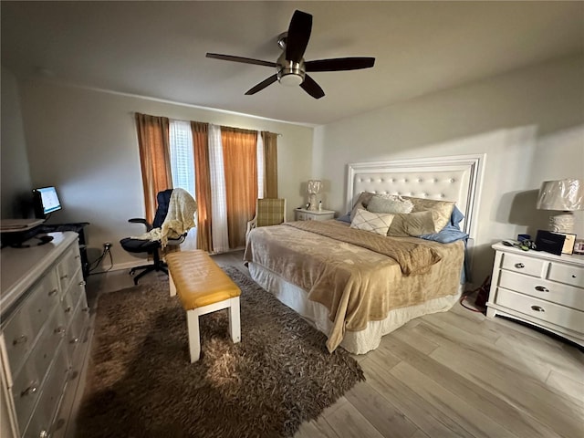 bedroom with ceiling fan and light hardwood / wood-style flooring