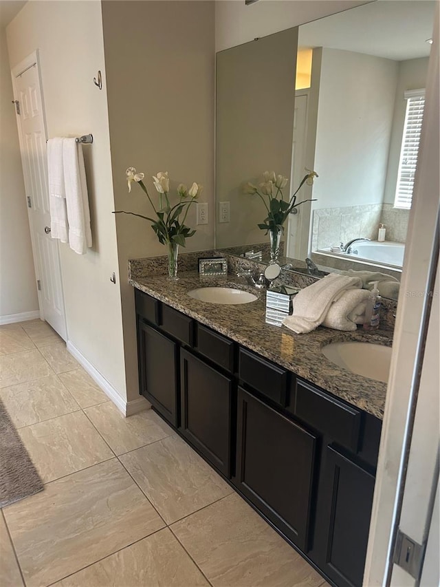 bathroom with vanity and a bath