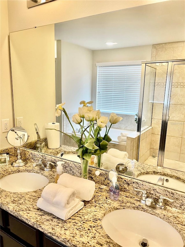 bathroom with vanity and a shower with door