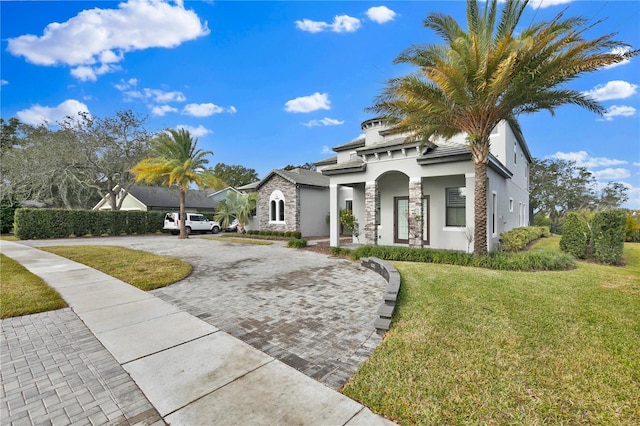 mediterranean / spanish-style home featuring a front lawn