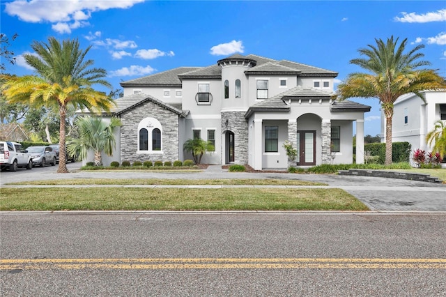 mediterranean / spanish house featuring a front yard