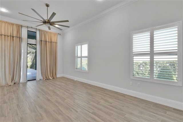 empty room with light hardwood / wood-style flooring, a wealth of natural light, crown molding, and ceiling fan