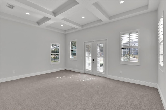 carpeted spare room featuring coffered ceiling, beam ceiling, and french doors