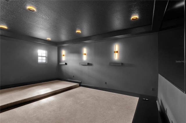 cinema room featuring carpet and a textured ceiling