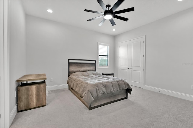 carpeted bedroom featuring ceiling fan and a closet