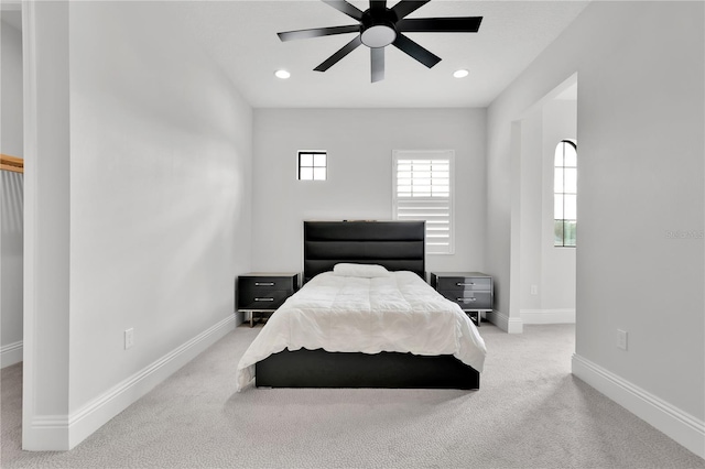 bedroom with light colored carpet and ceiling fan