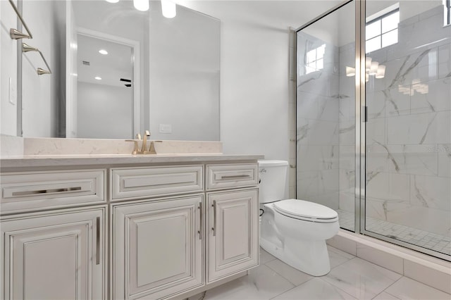 bathroom with vanity, toilet, and a shower with shower door