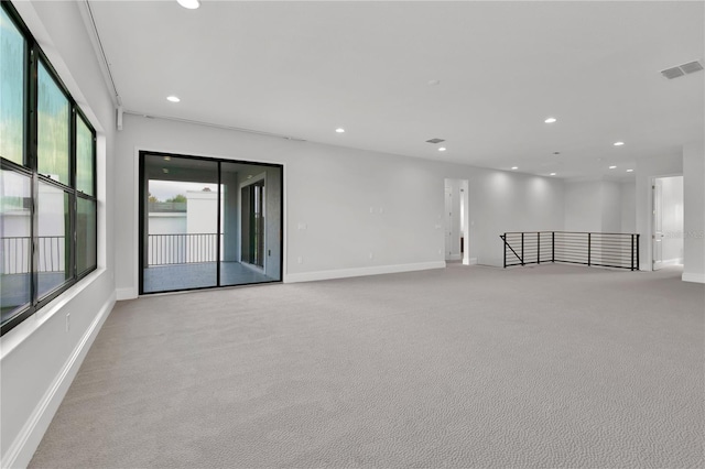 unfurnished room featuring light colored carpet