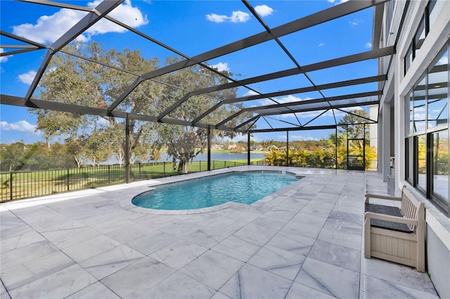 view of swimming pool with a patio area and a lanai