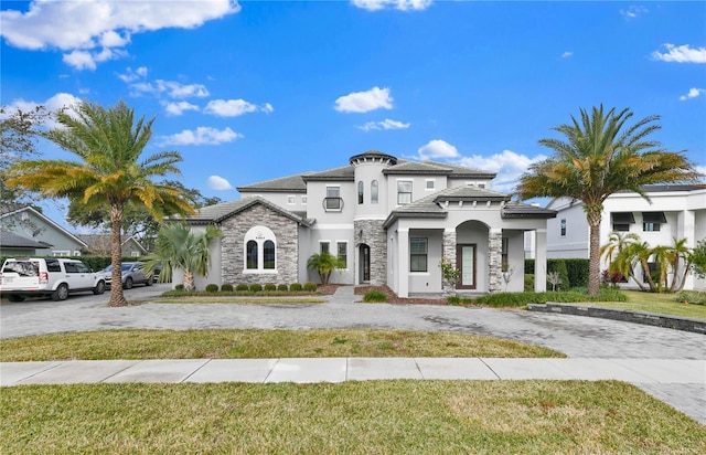 mediterranean / spanish house with a front yard