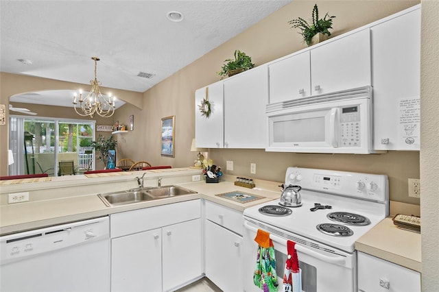 kitchen with white appliances, pendant lighting, an inviting chandelier, white cabinets, and sink