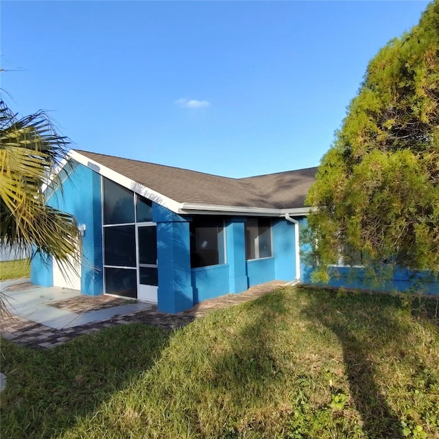 rear view of house with a lawn