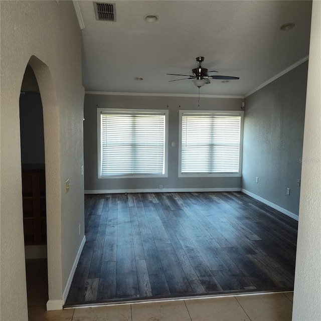 spare room featuring a wealth of natural light, crown molding, ceiling fan, and hardwood / wood-style flooring