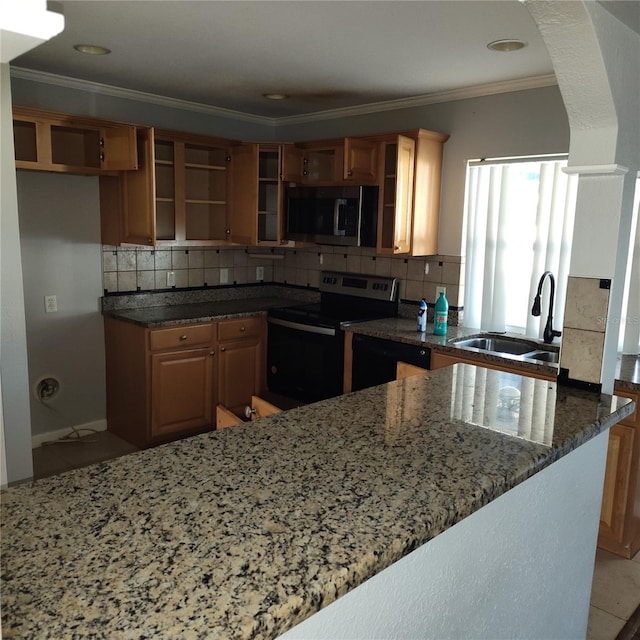 kitchen featuring kitchen peninsula, tasteful backsplash, stainless steel appliances, sink, and dark stone countertops