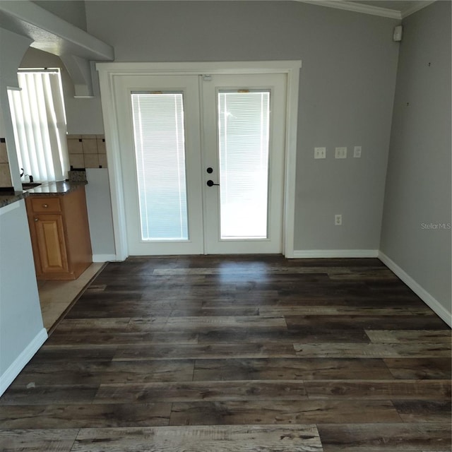 doorway to outside with dark hardwood / wood-style flooring, french doors, vaulted ceiling, and ornamental molding