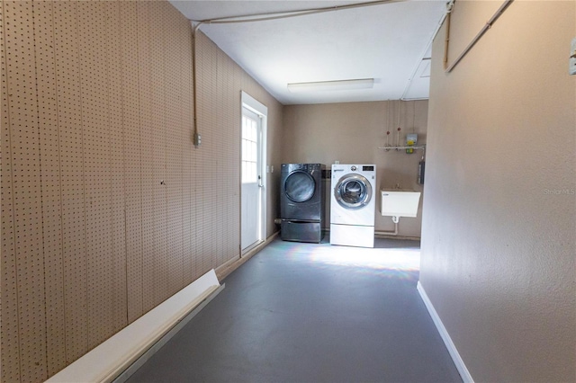 clothes washing area featuring washer and dryer and sink