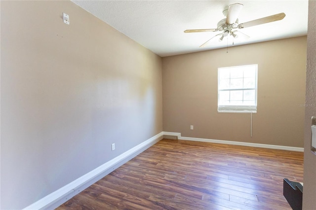 empty room featuring dark hardwood / wood-style floors and ceiling fan