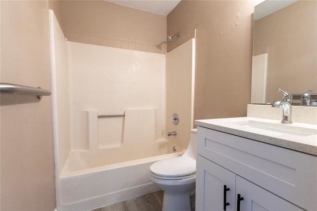 full bathroom with hardwood / wood-style flooring, vanity,  shower combination, and toilet