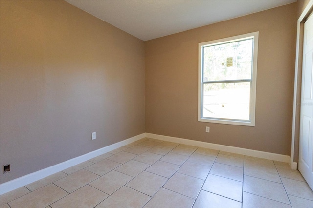 unfurnished room featuring light tile patterned floors and a wealth of natural light