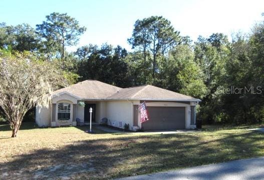 ranch-style home with a front yard and a garage