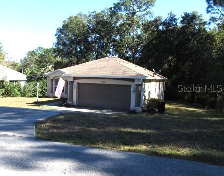 view of property exterior with a lawn and a garage