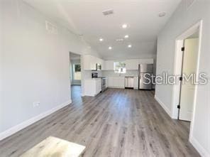 unfurnished living room featuring light wood-type flooring