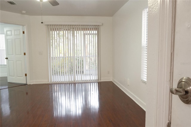 empty room featuring ceiling fan and dark hardwood / wood-style floors