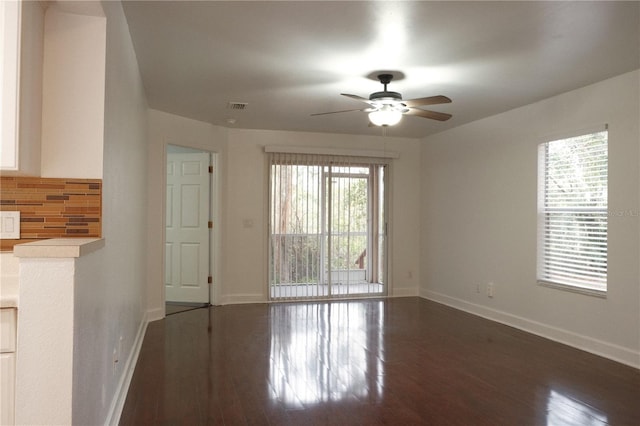 empty room featuring ceiling fan and dark wood-type flooring