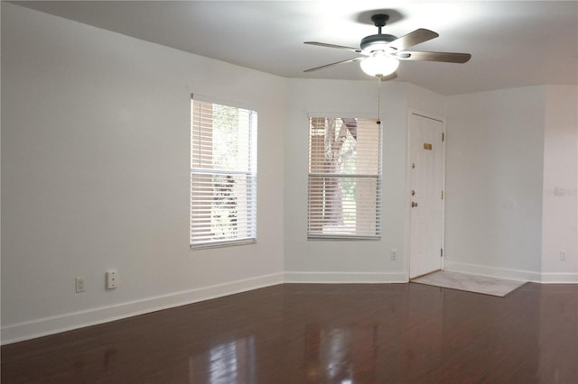 unfurnished room featuring plenty of natural light, dark hardwood / wood-style floors, and ceiling fan