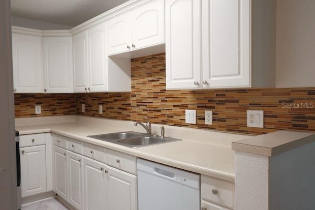 kitchen featuring white cabinetry, dishwasher, and tasteful backsplash