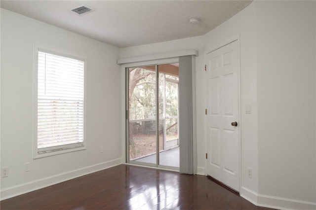 spare room with dark hardwood / wood-style flooring