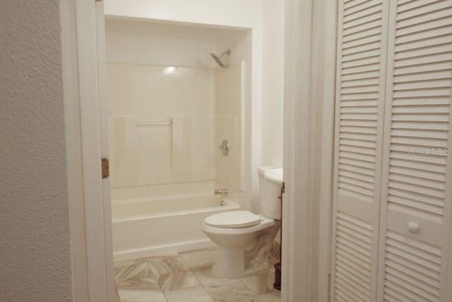 bathroom with shower / tub combination and toilet