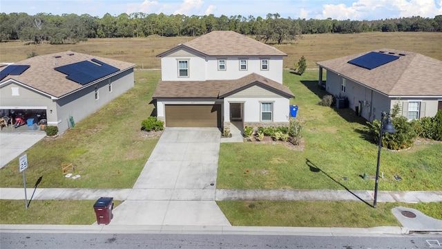 view of front of house with a front lawn and a garage