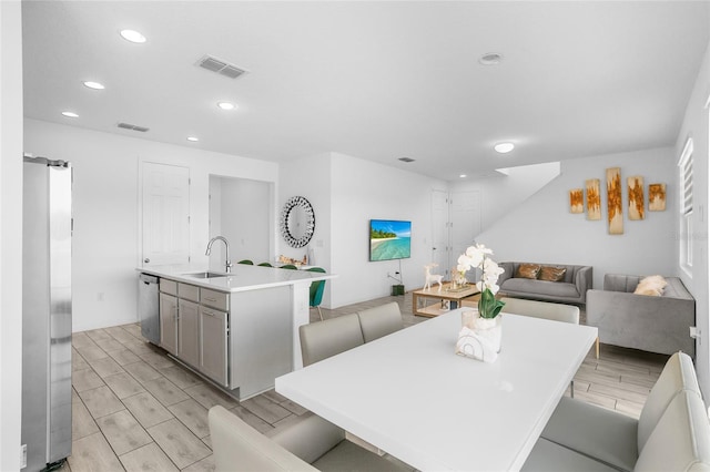 dining area with light hardwood / wood-style flooring and sink