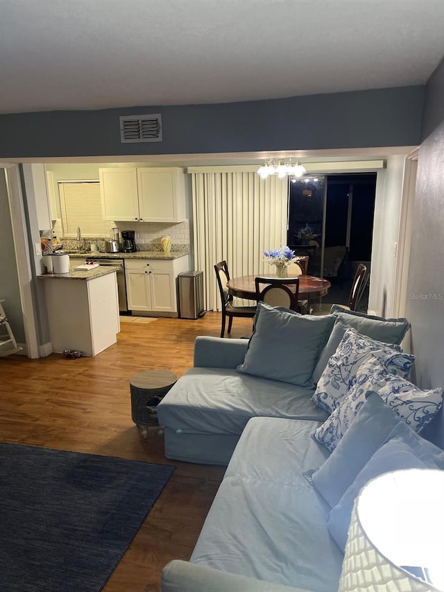 living room featuring wood-type flooring and sink