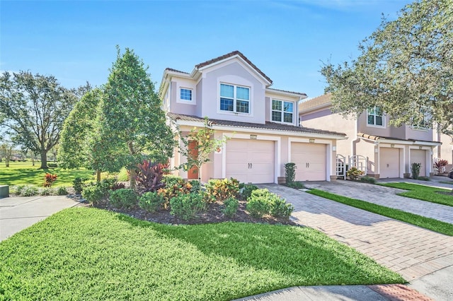 view of front of home with a front yard and a garage