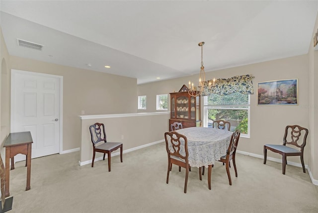 dining room featuring light carpet and a notable chandelier