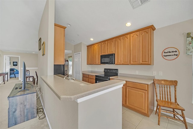 kitchen with black appliances, sink, light tile patterned flooring, kitchen peninsula, and a breakfast bar area