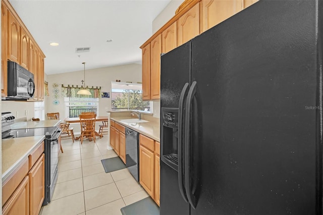 kitchen featuring vaulted ceiling, sink, black appliances, light tile patterned floors, and decorative light fixtures