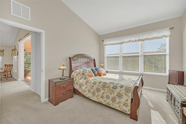 bedroom featuring multiple windows, light carpet, vaulted ceiling, and access to exterior