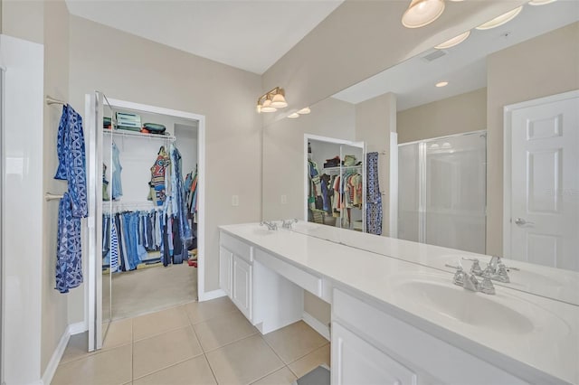 bathroom with tile patterned floors, vanity, and a shower with shower door