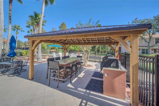 view of patio / terrace with a gazebo and an outdoor bar