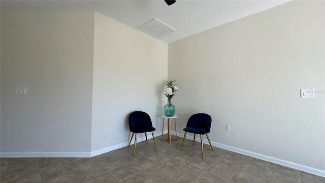 unfurnished room featuring dark tile patterned floors and a textured ceiling