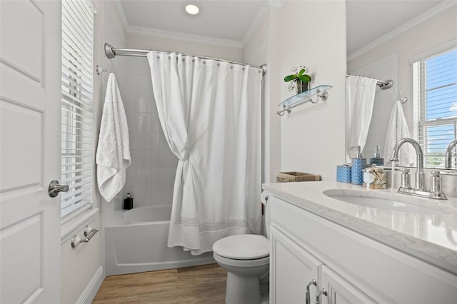 full bathroom featuring toilet, hardwood / wood-style flooring, shower / bathtub combination with curtain, crown molding, and vanity