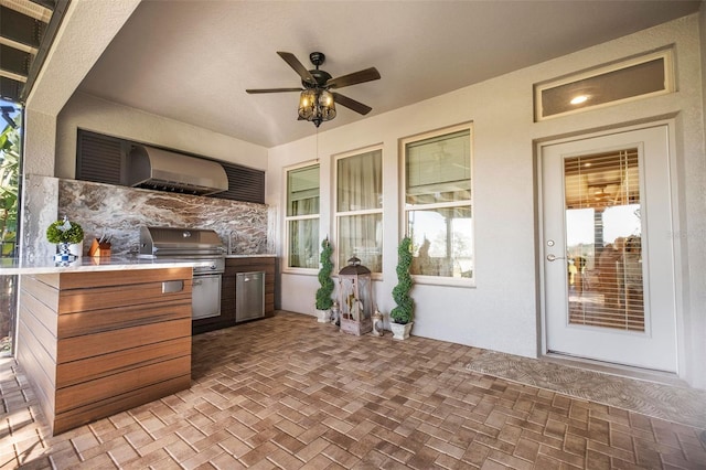 view of patio featuring ceiling fan, area for grilling, and sink