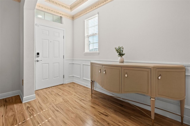 entrance foyer featuring light hardwood / wood-style flooring and ornamental molding