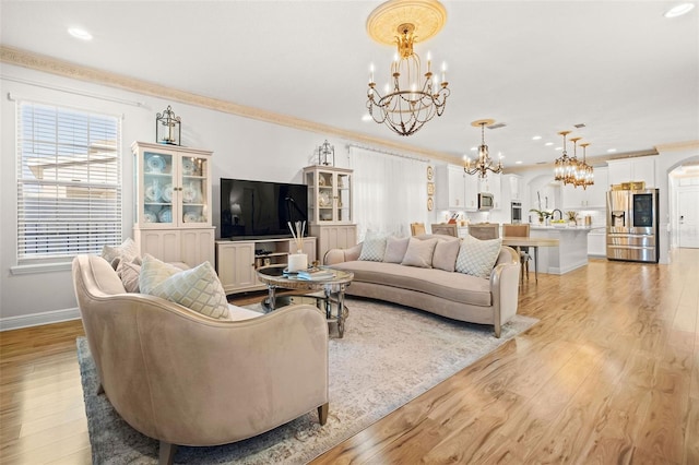 living room featuring crown molding and light hardwood / wood-style flooring